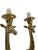 This is a pair of sculptural brass wall sconces in the form of elongated giraffes, each supporting a single candle-style...
