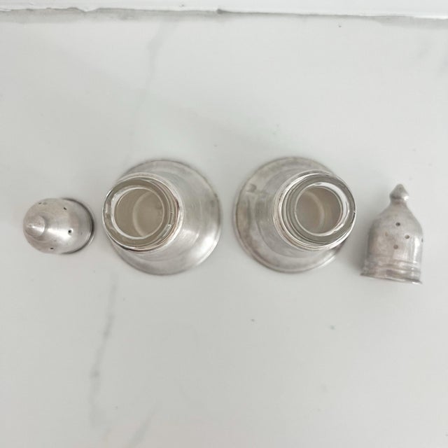 Matching pair set of sterling silver salt and pepper shakers, marked “National Sterling Weighted, Pat. No 2646954” ....