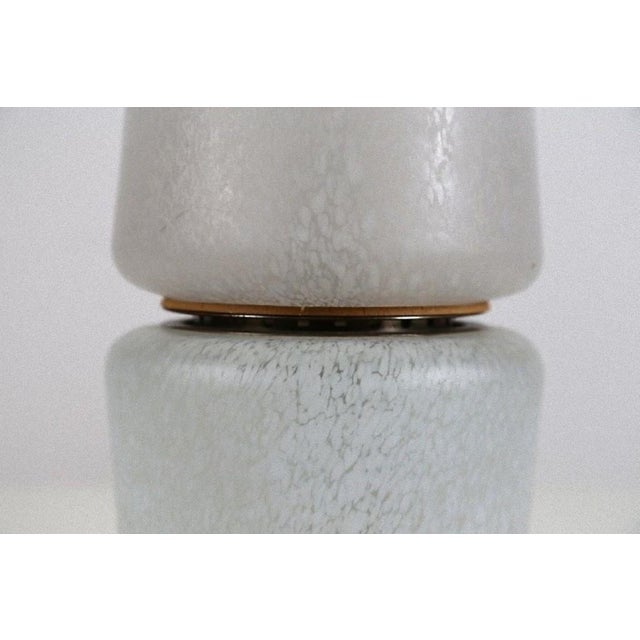 This vintage table lamp is a refined design lamp manufactured in Italy in the 1960s. White ceramic table lamp whose soft...