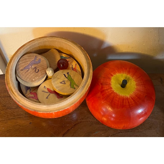 Antique early 20th century paint decorated carved wood apple box with a child's steeplechase horse race game inside....