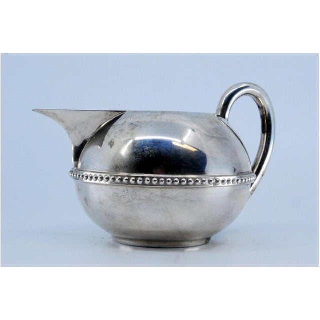 Silver Teapot with Raised Surround on the Frieze, in Very Good conditions. Designed 1890 to 1919 This piece has an...
