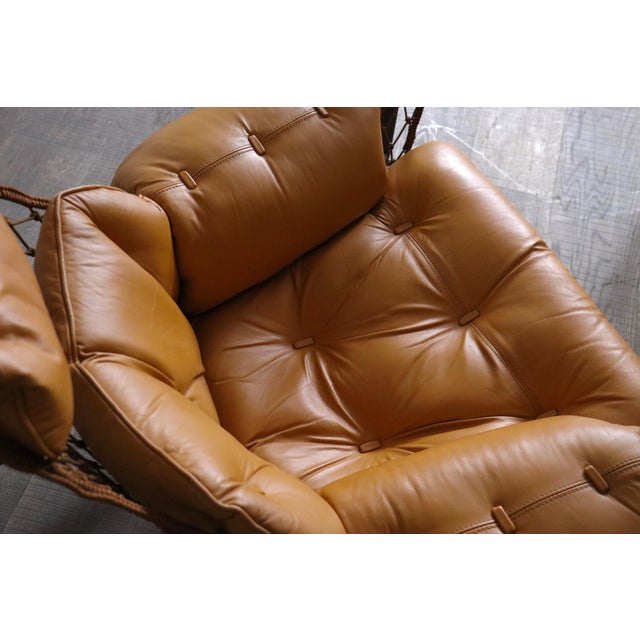 Jangada lounge chair with ottoman in cognac leather by jean gillon, brazil 1960s a breathtaking design which was inspired...