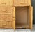 This vintage woven rattan and wood sideboard is a beautifully crafted example of mid-century design, blending natural...