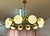 Elegant Italian chandelier handcrafted in Murano, featuring ten white Murano glass spheres arranged in a refined circular...