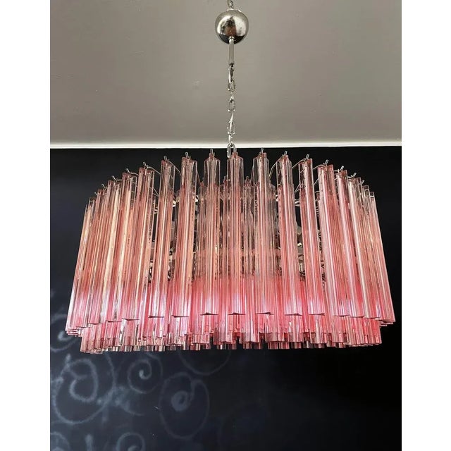 A magnificent Murano glass chandelier, 265 pink triedri on crome frame. This large Mid-Century Italian chandelier is truly...
