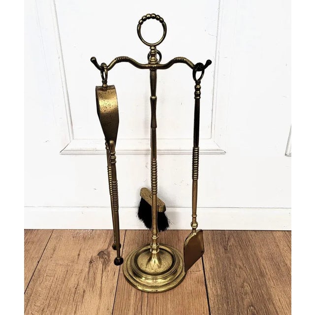 Beautiful Italian brass three-piece fire tool set with stand. The set consists of a poker, a shovel and a pair of tongs,...
