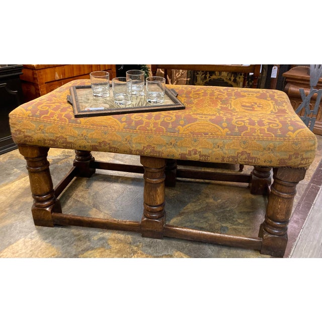 Antique oak upholstered bench or ottoman, in a wonderful fabric with shields containing horses, castles, crowns, garlands...