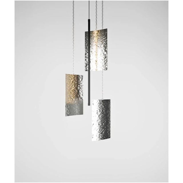 Svitlotin Collection: Where light meets shadow. These elegant curved pendant lights feature premium satin stainless steel...