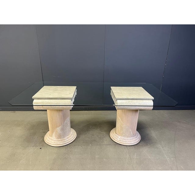 Gorgeous dining table made from tessellated stone pedestal in greek style. The dining table has a clear glass beveled edge...