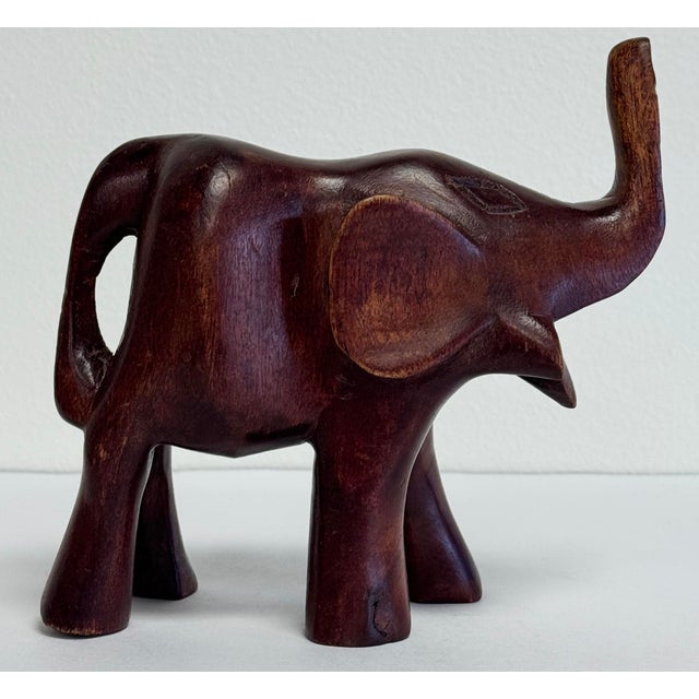 Vintage beautifully carved wood elephant figurine with a raised trunk for good luck. Age wear. No breaks.