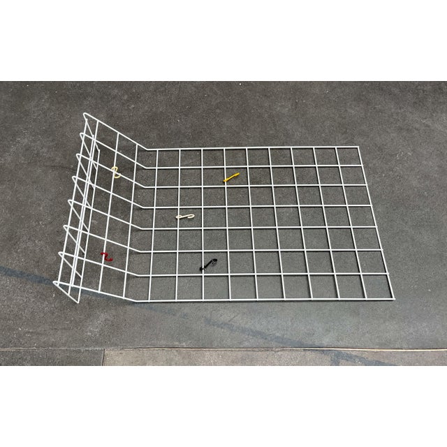 Minimalist mid-century wire coat rack. Simple coat rack made of coated metal mesh. The top section is shaped like a shelf....