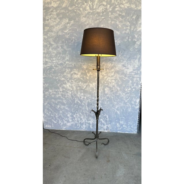 A striking Spanish silvered iron floor lamp from the 1950s, featuring an elegant twisted stem with finely crafted foliate...
