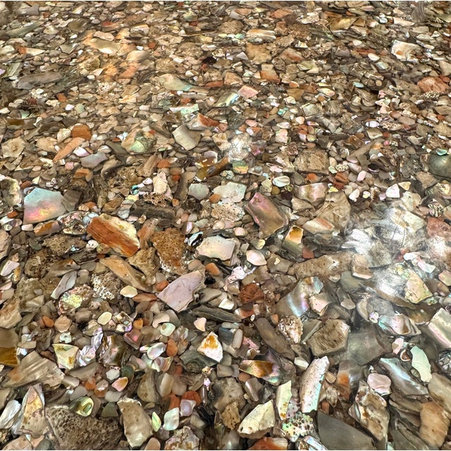 A stunning, highly detailed, custom made circular dining table with real abalone shell pieces encased in resin with a...