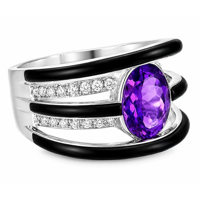 This stunning 14K white gold band ring is a true statement piece, featuring a vibrant natural oval amethyst at its center,...