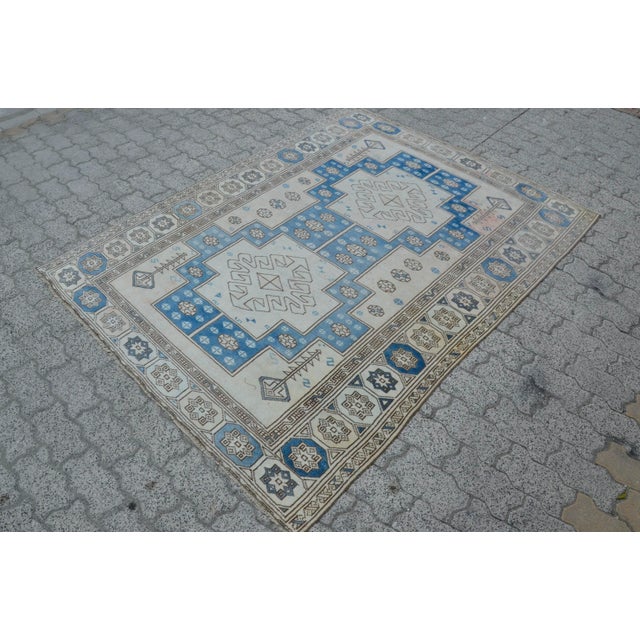 This is a vintage Turkish Oushak rug from the 1960s. The piece was hand-knotted.