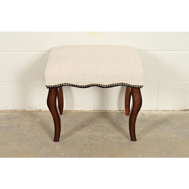 A gorgeous French Provincial Louis XV style ottoman or footstool In the manner of Baker Furniture By Hillsdale Furniture...
