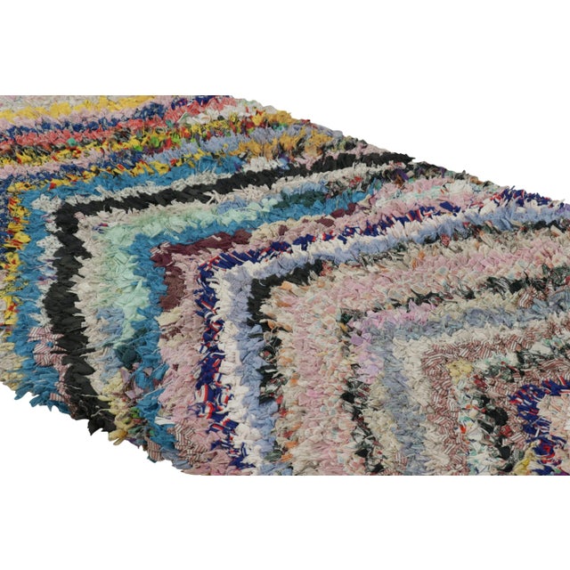 Hand-knotted in wool and originating from Morocco circa 1950-1960, this 2x5 vintage Moroccan rug is an extremely rare...