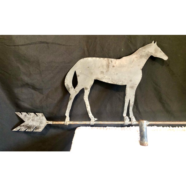 On offer is an antique American folk art horse silhouette weathervane, likely dating from the late 19th century to the...