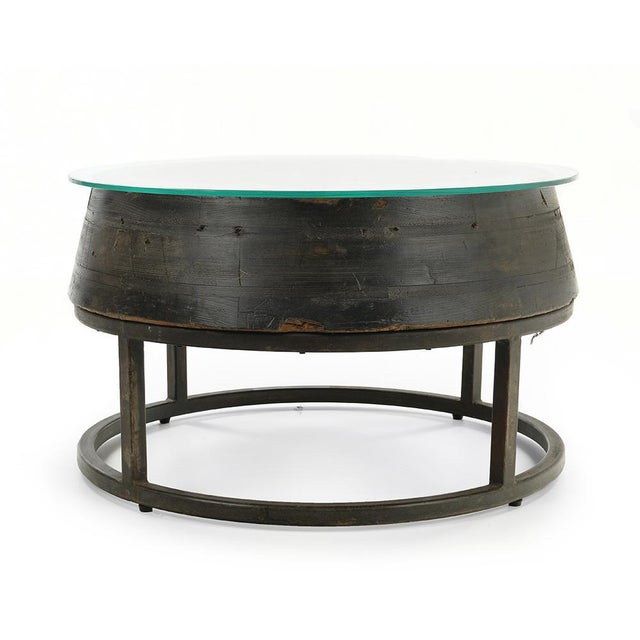 Coffee table in wood with glass top and cast iron base. This piece is designed in the style of the selected designer...
