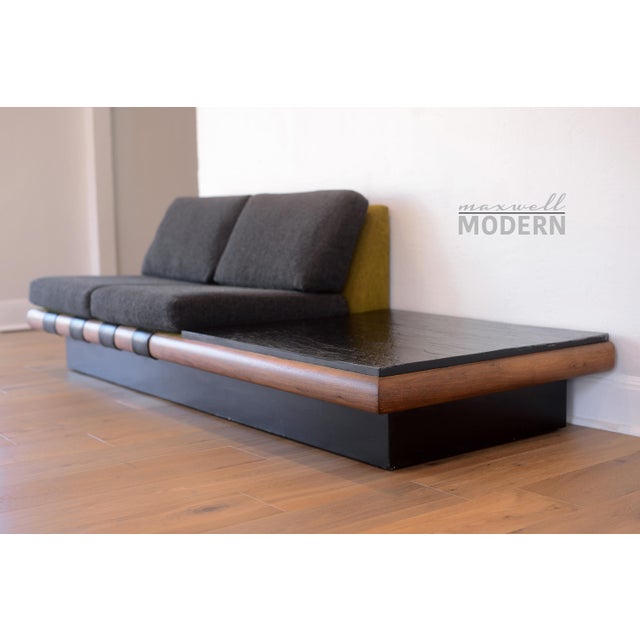 Amazing mid century modern platform sofa designed by Adrian Pearsall for Craft Associates with a built-in black slate end...