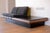 Amazing mid century modern platform sofa designed by Adrian Pearsall for Craft Associates with a built-in black slate end...