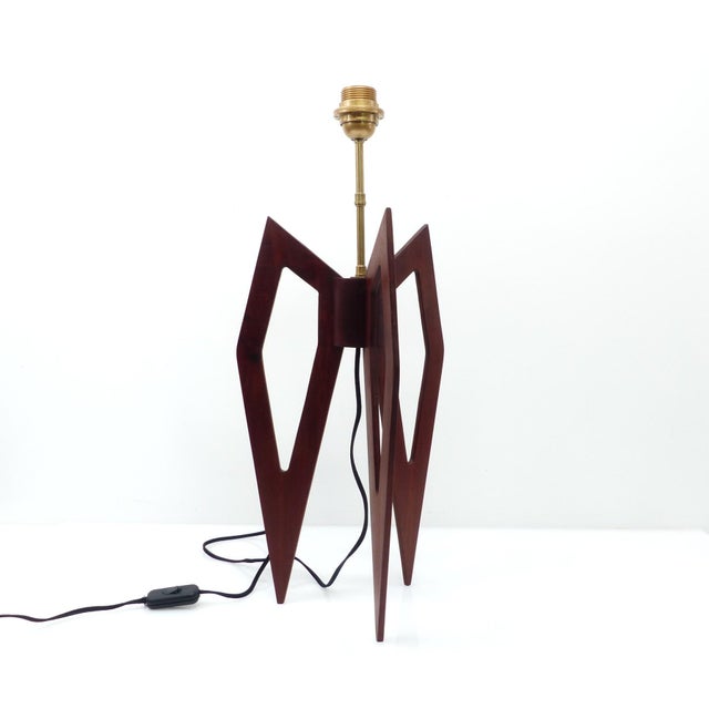 Vintage table lamp base with a sculptural, tripod base in mahogany-brown stained wood, both graphic and architectural. The...