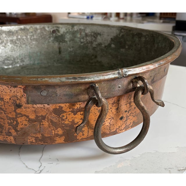 Offering a special find from an old estate in south Louisiana. This large French copper pan has hand forged iron handles...