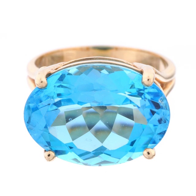 Vintage 14K Gold Blue Topaz Cocktail Ring, size 7.5. Ring features a vibrant oval-cut blue topaz in a sky-blue hue,...