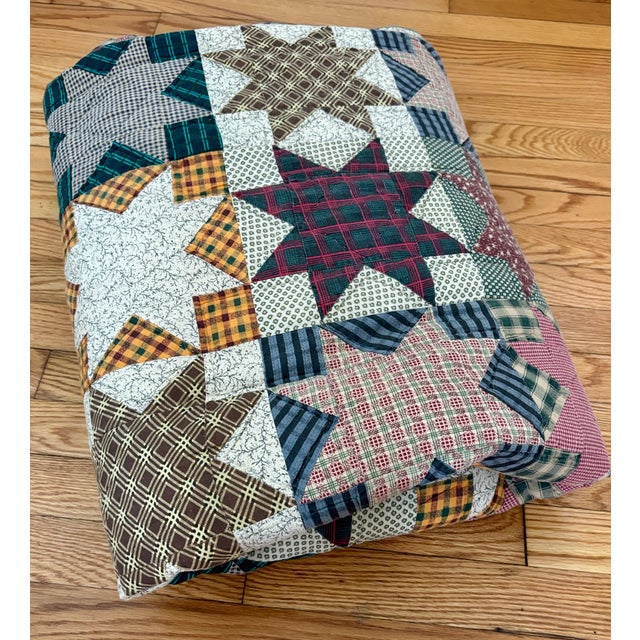 Beautiful vintage Americana star pattern handmade quilt in blues, reds, yellows, and greens. Measuring at 86" x 95", it is...