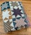 Beautiful vintage Americana star pattern handmade quilt in blues, reds, yellows, and greens. Measuring at 86" x 95", it is...
