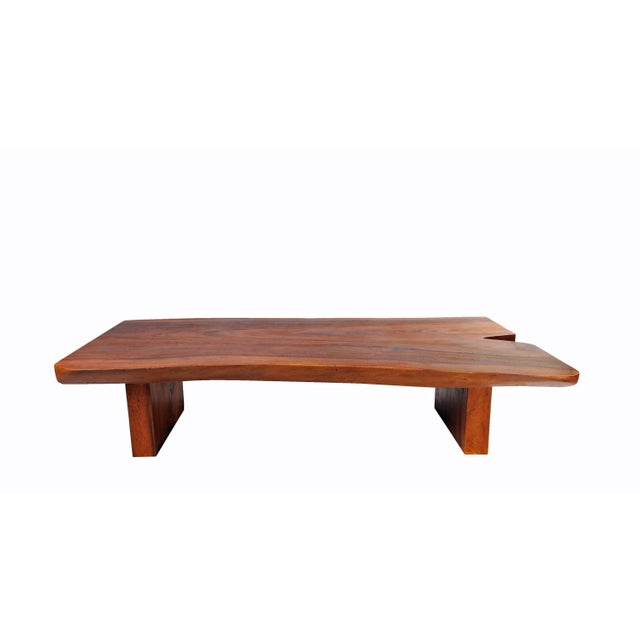 Hand made from one single slab of wood, the top of this brown color coffee table is hand selected, cut, and polished to...