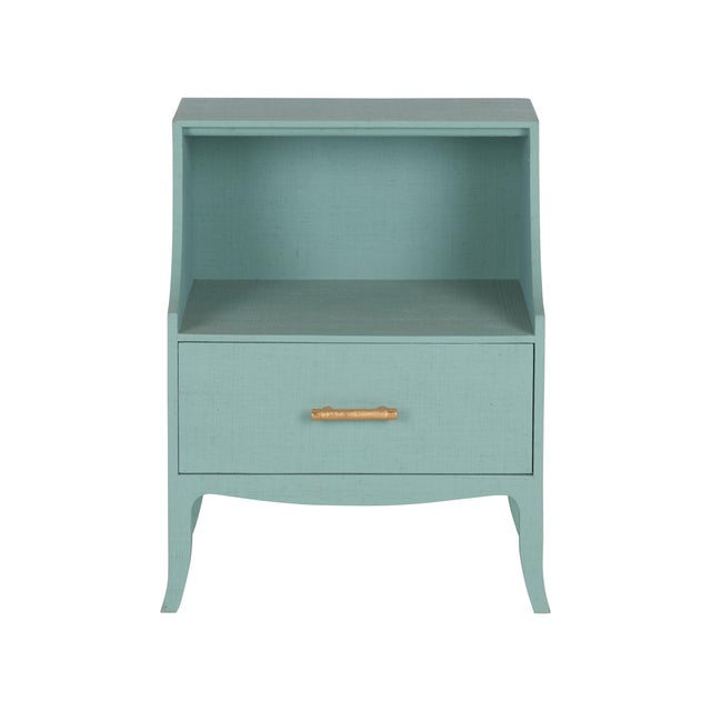 Elevate your bedroom with this chic bedside table, artfully wrapped in natural raffia for a textured, organic appeal. A...