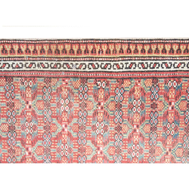 An exquisite early 20th-century hand-woven Persian Serab runner rug featuring a vibrant rust-red field adorned with an...