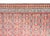 An exquisite early 20th-century hand-woven Persian Serab runner rug featuring a vibrant rust-red field adorned with an...