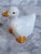 Charming pair of white ceramic duck napkin rings with adorable detailing. The original made in Taiwan sticker is on the...