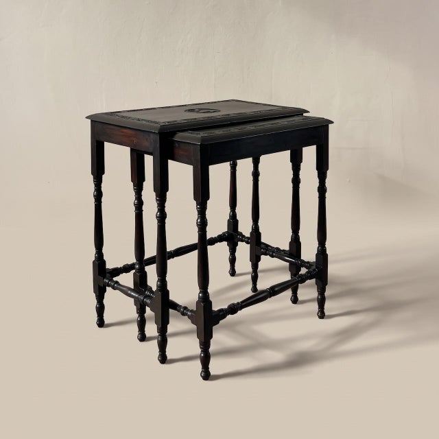 A rare and characterful pair of late victorian pair of nesting tables, circa 1880–1895. each table features a deep floral...