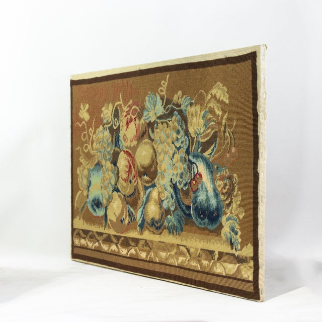 This exquisite vintage needlework tapestry features a lush still life of bountiful fruit, including clusters of grapes,...