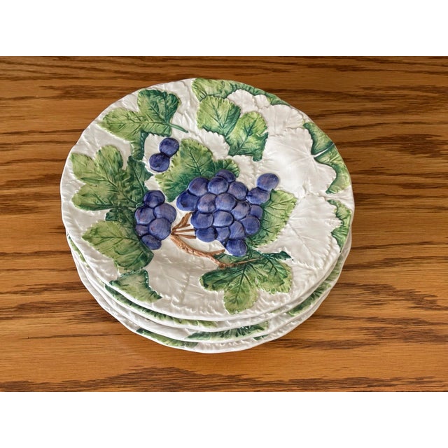 A beautiful set of four mid 20th-Century Italian majolica plates. Hand painted with rich purple grapes and leaves. Made in...