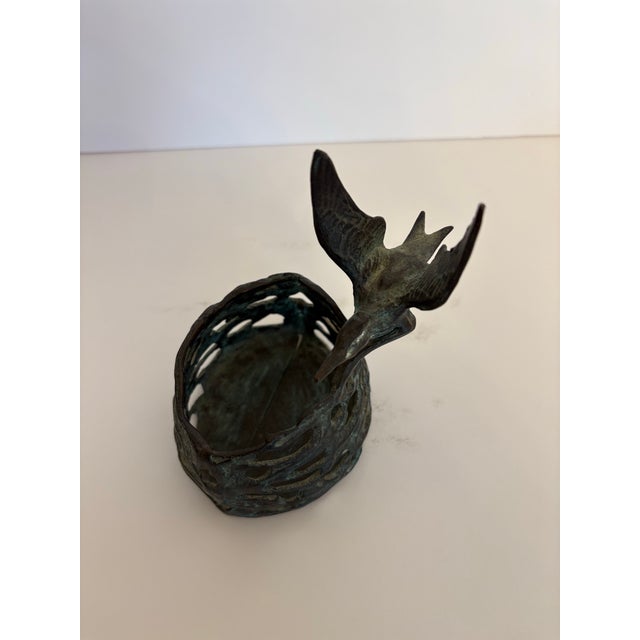 This is a bronze art deco 1940's pillar candle holder or catch all dish pierced base with a hummingbird perched on the...
