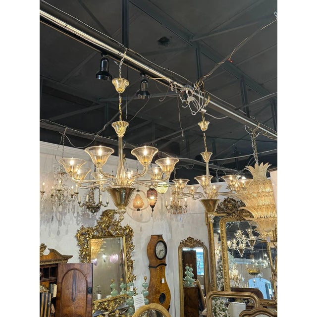 Modern Murano gold glass 8-arm chandelier. Circa 2000. The chandelier has been professionally re-wired, cleaned and is...