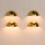 Rare pair of Italian Space Age wall sconces designed by Gilla Giani for Tronconi in the 1980s. These sculptural brass...