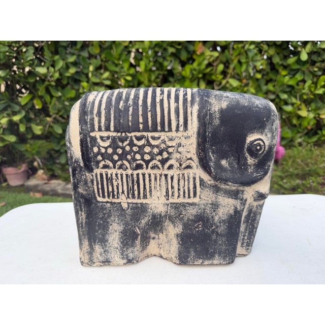 A striking vintage terracotta elephant sculpture finished in a hand-rubbed blackwashed patina that highlights the natural...