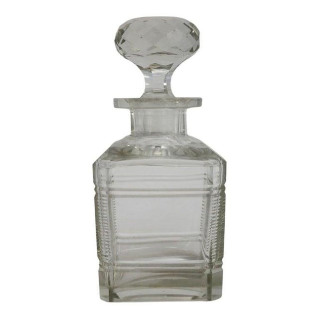 This collection features four vintage diminutive spirit decanters, crafted from a combination of cut and pressed glass....
