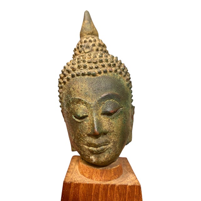 This is a beautiful, highly detailed Thai bronze Buddha head fragment, presented on a vintage custom-carved tapered wooden...