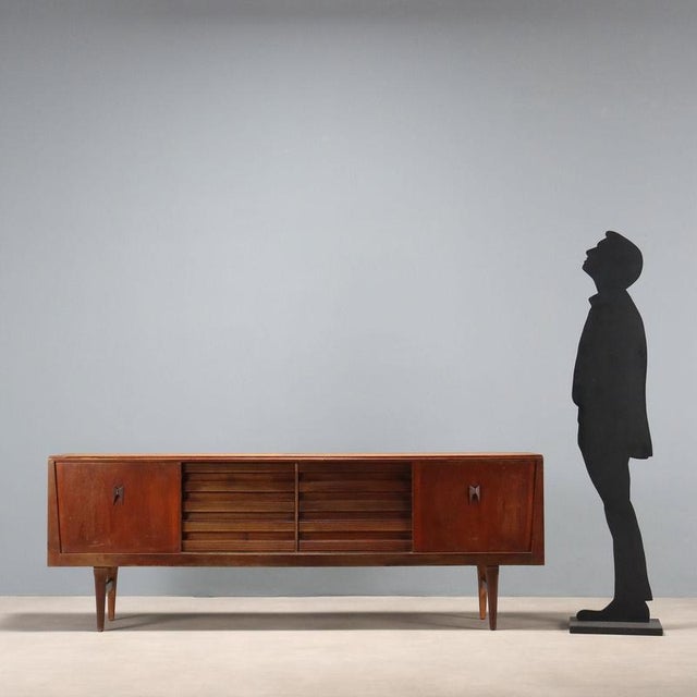 Vintage Northern European-made teak veneered sideboard with hinged doors and drawers. Requires restoration, which can be...