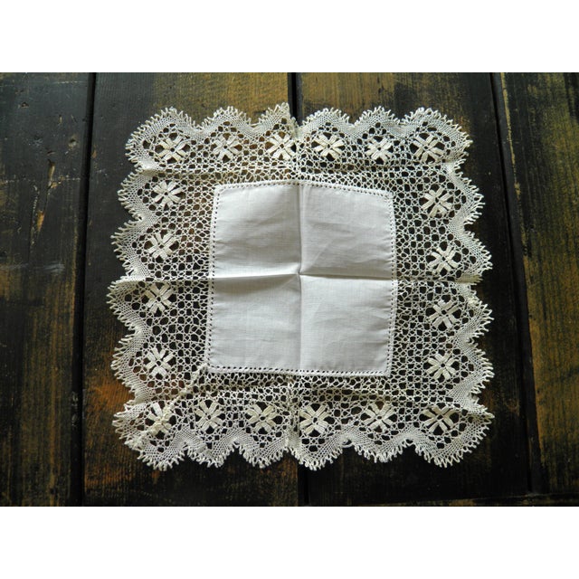 This delicate handkerchief is a refined example of early 20th-century lingerie, notable for its handcrafted quality....