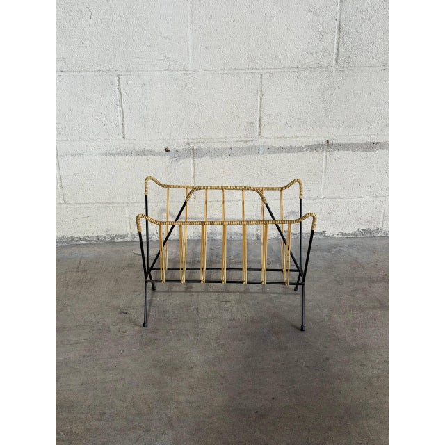 An open wire frame construction defines this functional piece, styled with a geometric V-shaped profile. Integrated top...