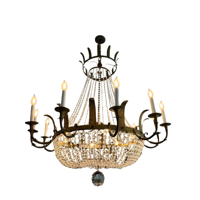 Mid-20th century Empire-style chandelier with a gilt metal frame and basket form design. The frame features feathered...