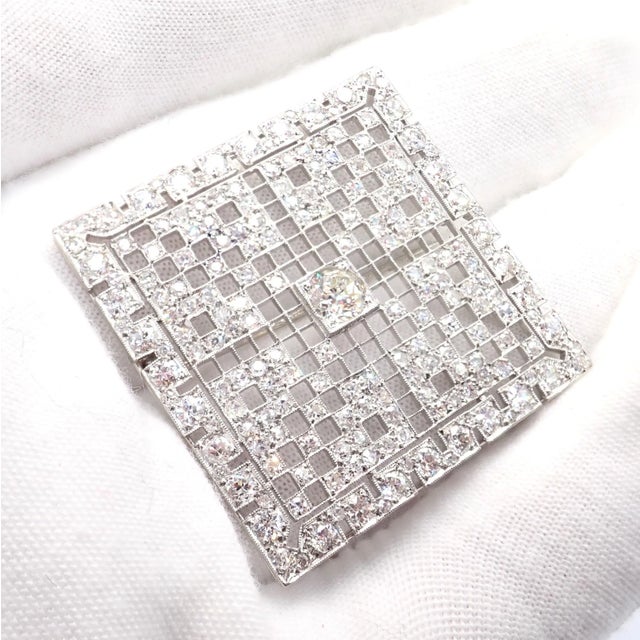 This vintage Art Deco brooch showcases timeless elegance in platinum, adorned with approximately 5 carats total weight of...