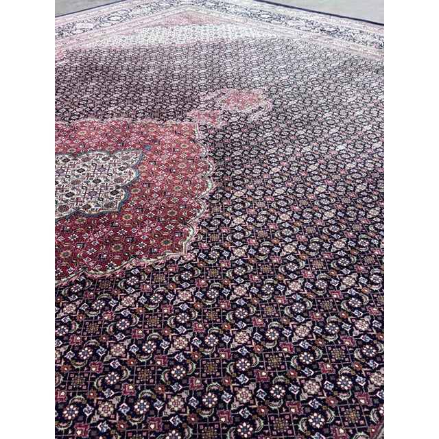 Design Plus Gallery presents a 9ft 10in × 12ft 10 in Tabriz Persian Rug. A true masterpiece of traditional craftsmanship,...